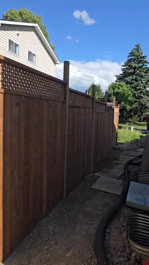 Custom wood privacy fence with decorative lattice top
